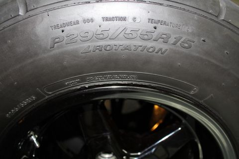 2003 Ford Crown Victoria - Close-up of a P295/55R15 tire, showing treadwear and traction ratings.