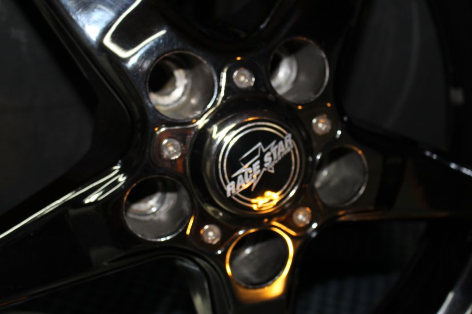 Close-up of polished wheel center cap with Race Star logo