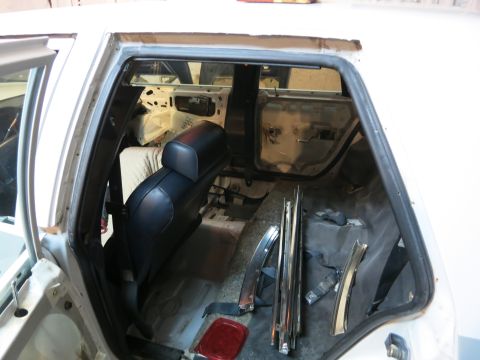 1991 Ford Crown Victoria LTD - The interior of a car is shown with the rear seat in place and the rest of the interior stripped down for work.