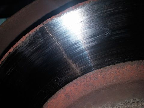 2000 Mercury Grand Marquis - Close-up view of a cracked brake rotor, indicating potential mechanical failure.