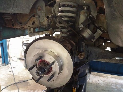 2000 Mercury Grand Marquis - Vehicle brake rotor and suspension components are visible in this close-up shot.