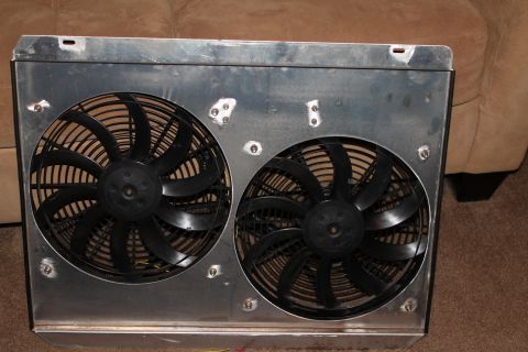 1995 Ford Bronco - A pair of electric cooling fans are mounted in a metal shroud, likely for an automotive application.