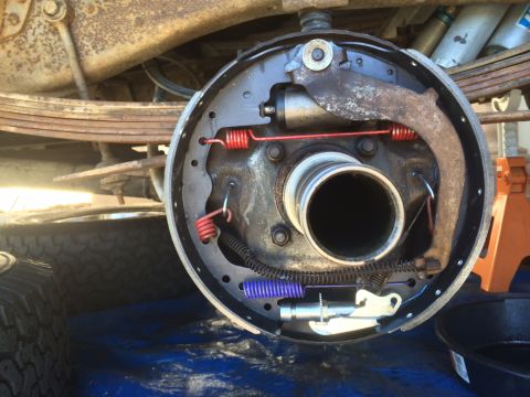1977 Ford F-350 - The rear drum brake assembly is shown with new brake shoes and springs, ready for reassembly.