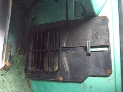 1977 Ford F-350 - Close-up of an interior vent cover with a slider mechanism against a green painted surface.