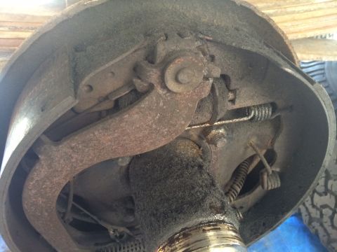 1977 Ford F-350 - Close-up view of a vehicle's rear drum brake assembly, showing internal components and signs of wear.