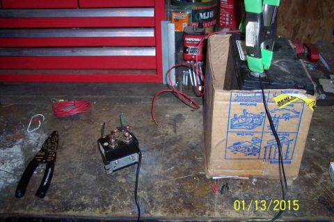 1973 Ford F-250 - Wiring a battery to a winch solenoid with jumper cables and wire strippers on a workbench.