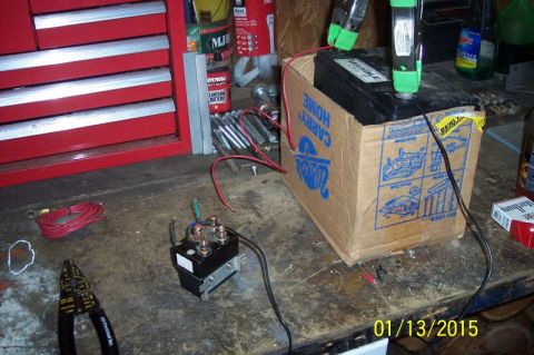 1973 Ford F-250 - A car battery is placed in a cardboard box, connected to a relay and other wiring components.