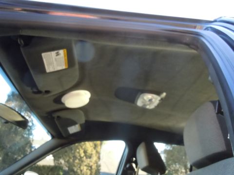 2001 Ford Crown Victoria - The interior ceiling of a vehicle shows two sun visors and two overhead lights.