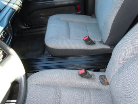 2001 Ford Crown Victoria - Interior view showing front seats and seatbelts of a car.