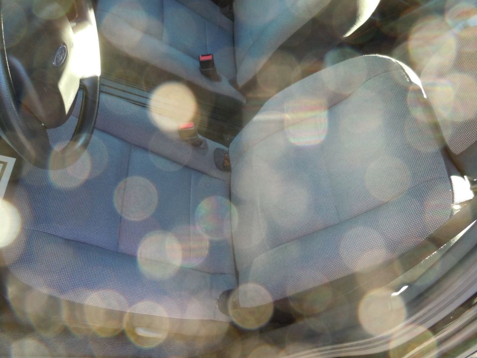 Car interior showing front seats and steering wheel