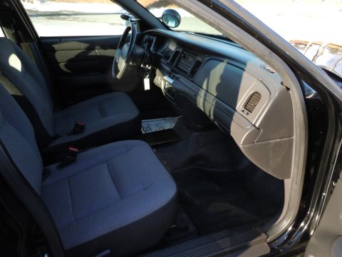 2001 Ford Crown Victoria - Interior view of a 2001 Ford Crown Victoria, showing the front seats and dashboard.