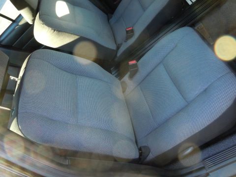 2001 Ford Crown Victoria - The interior of a car shows the front and rear seats, with seatbelts fastened.