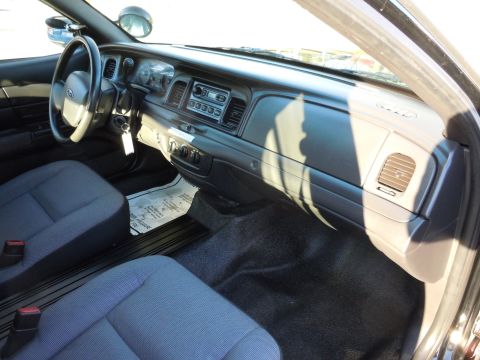 2001 Ford Crown Victoria - Interior view of a 2001 Ford Crown Victoria, highlighting the dashboard and seating arrangement.
