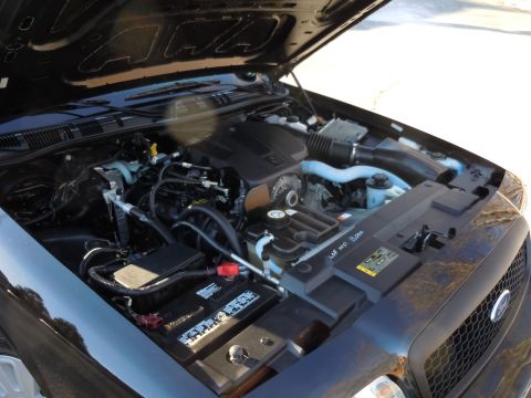 2001 Ford Crown Victoria - The engine compartment of a 2001 Ford Crown Victoria is open, revealing the V8 engine and associated components.