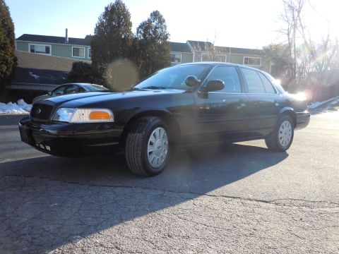 2001 Ford Crown Victoria - This 2001 Ford Crown Victoria is captured in a 3/4 front view, its classic sedan body style.