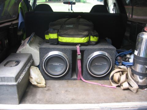 1988 Ford Bronco - The cargo area of a 1988 Ford Bronco is filled with various items, including a large speaker box with two subwoofers, a duffel bag with ref…