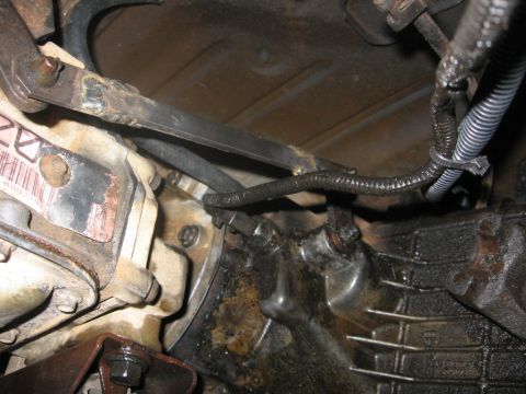 1988 Ford Bronco - This image shows the underside of a vehicle, focusing on the transmission and related components. Visible parts include the transmission ho…