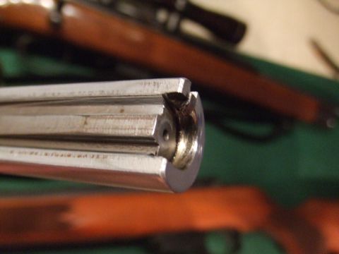1996 Ford Bronco - Close-up view of the internal mechanism of a firearm, likely a bolt action rifle, with wooden stock visible in the background.