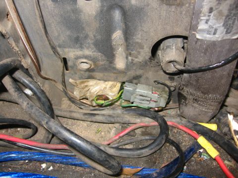 1988 Ford Bronco - Wiring harness connector with multiple cables visible in a dirty area.