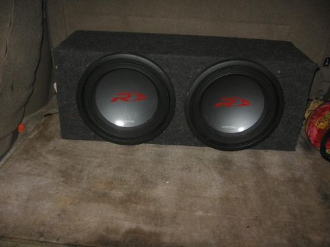 1988 Ford Bronco - A dual subwoofer box with Alpine R-series speakers is installed in the cargo area of a vehicle. The box is covered in dark grey carpet and…