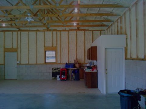 1995 Mercury Grand Marquis - Interior view of a garage space, showing storage cabinets, a workbench, and doors.