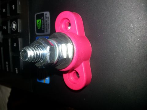 1994 Ford Bronco - Close-up of a pink battery terminal connector, likely for a car audio system.
