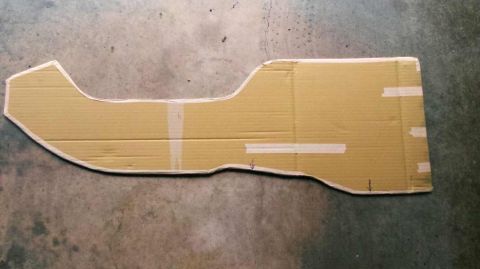 1982 Ford Bronco - A cardboard template is laid out on a concrete floor, likely for a custom car part.