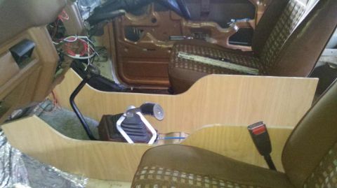 1982 Ford Bronco - Interior view of a vehicle's console area, showing unfinished wood and exposed wiring.