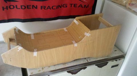 1982 Ford Bronco - A wooden prototype of a car console is shown with taped seams and drawn outlines.