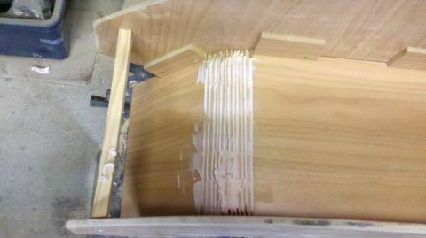 1982 Ford Bronco - Close-up of a wooden console interior showing glue application and wood texture.