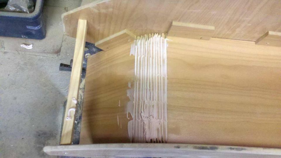 Wooden console interior with visible glue lines and wood grain