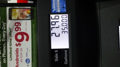 1995 Ford Bronco - A gas pump display shows the sale price and gallons dispensed, next to a phone advertisement.