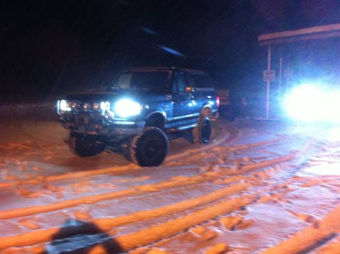 1988 Ford Bronco - 1988 Ford Bronco driving through snow at night.
