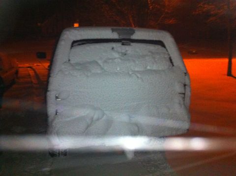 1988 Ford Bronco - A snow-covered SUV is parked outside at night, with a watermark visible at the bottom right.