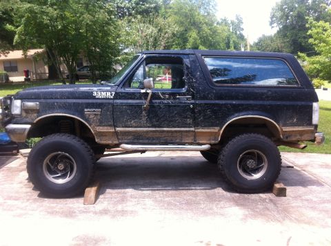1988 Ford Bronco - This 1988 Ford Bronco is lifted and covered in mud, resting on wooden blocks.