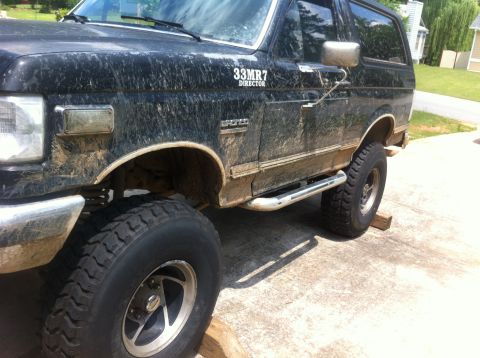 1988 Ford Bronco - This 1988 Ford Bronco is covered in mud, showing its 'SPORT' trim and custom '33MR7 DIRECTOR' decal.