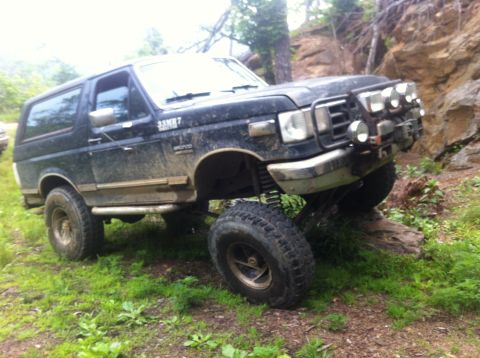 1988 Ford Bronco - This 1988 Ford Bronco is navigating a challenging off-road course with steep inclines.