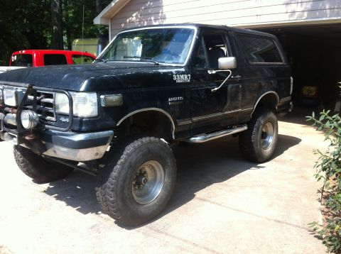 1988 Ford Bronco - Black 1988 Ford Bronco parked in a driveway, showing off its lifted suspension and off-road tires.
