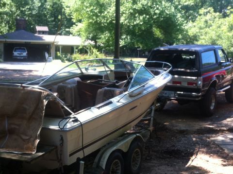 1988 Ford Bronco - A black 1988 Ford Bronco is seen from the rear, hitched to a boat on a trailer.