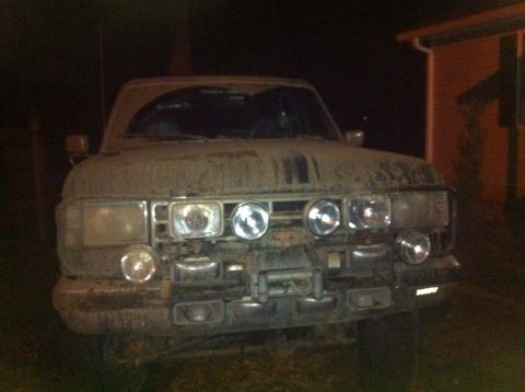 1988 Ford Bronco - This 1988 Ford Bronco is covered in mud and features numerous auxiliary lights and a front-mounted winch.