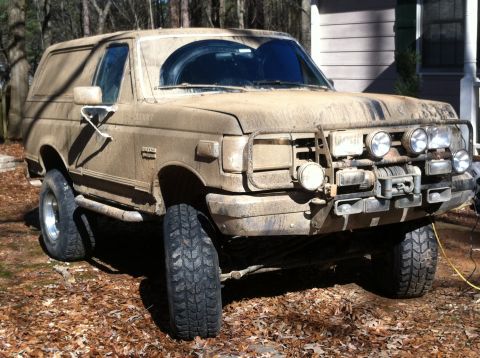 1988 Ford Bronco - This heavily soiled Ford Bronco sits in a yard, ready for its next off-road adventure.