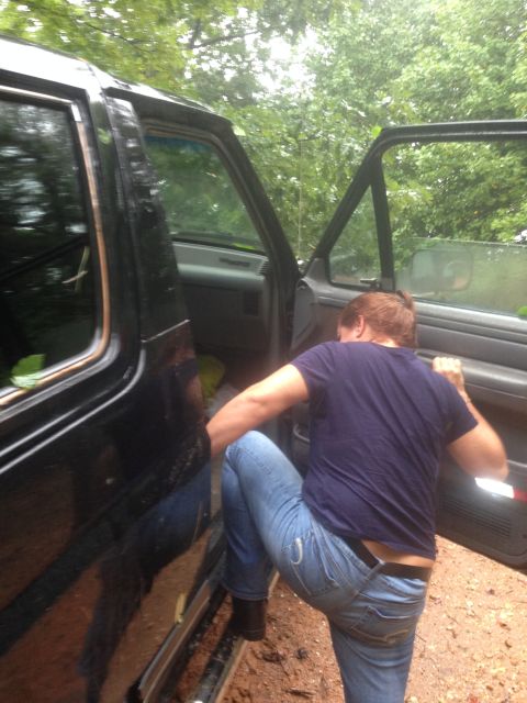 1988 Ford Bronco - A person enters the driver's side of a black 1988 Ford Bronco.
