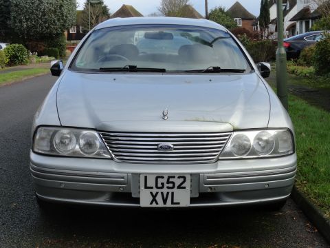 1999 Ford Fairlane - Silver sedan with license plate LG52 XVL parked on a residential street.