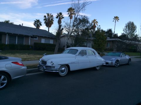 1968 Ford Mustang - A 1948 Packard sedan is parked on a residential street next to two other cars.