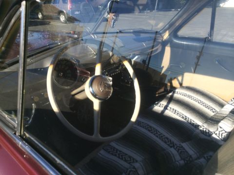 1968 Ford Mustang - Interior view of a classic car, with a blanket covering the passenger seat and an SUV reflected in the glass.