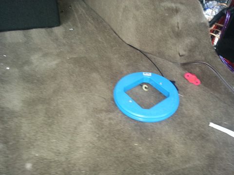 1994 Ford Bronco - Photo of a blue fish-tape spool on trunk carpet used for routing audio wiring.