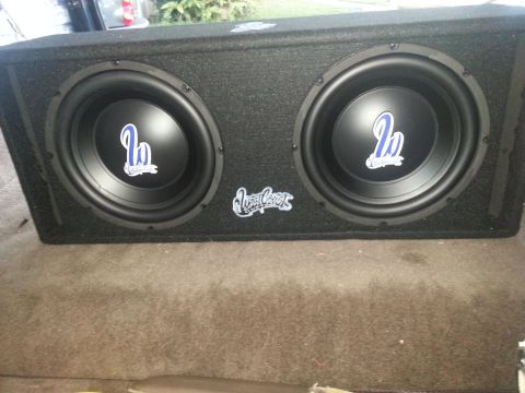 1994 Ford Bronco - Photo of two West Coast 12-inch subwoofers installed in a carpeted ported enclosure.