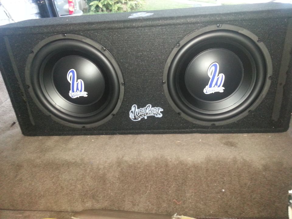 Dual West Coast 12-inch subwoofers mounted in a carpeted ported enclosure
