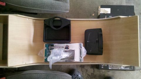 1982 Ford Bronco - A custom wooden center console with a chrome gear shifter assembly and black plastic inserts is laid out on the floor. The console appears…
