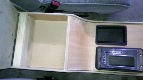 1982 Ford Bronco - A custom wooden center console with a storage compartment and a gear shift indicator is installed in a vehicle, next to a car seat.